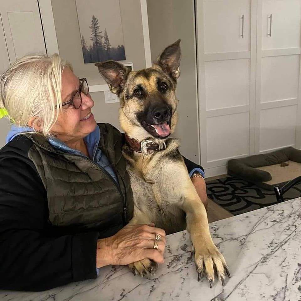 Julie smiling with a dog